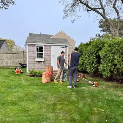 GB Landscape crew trimming shrubs