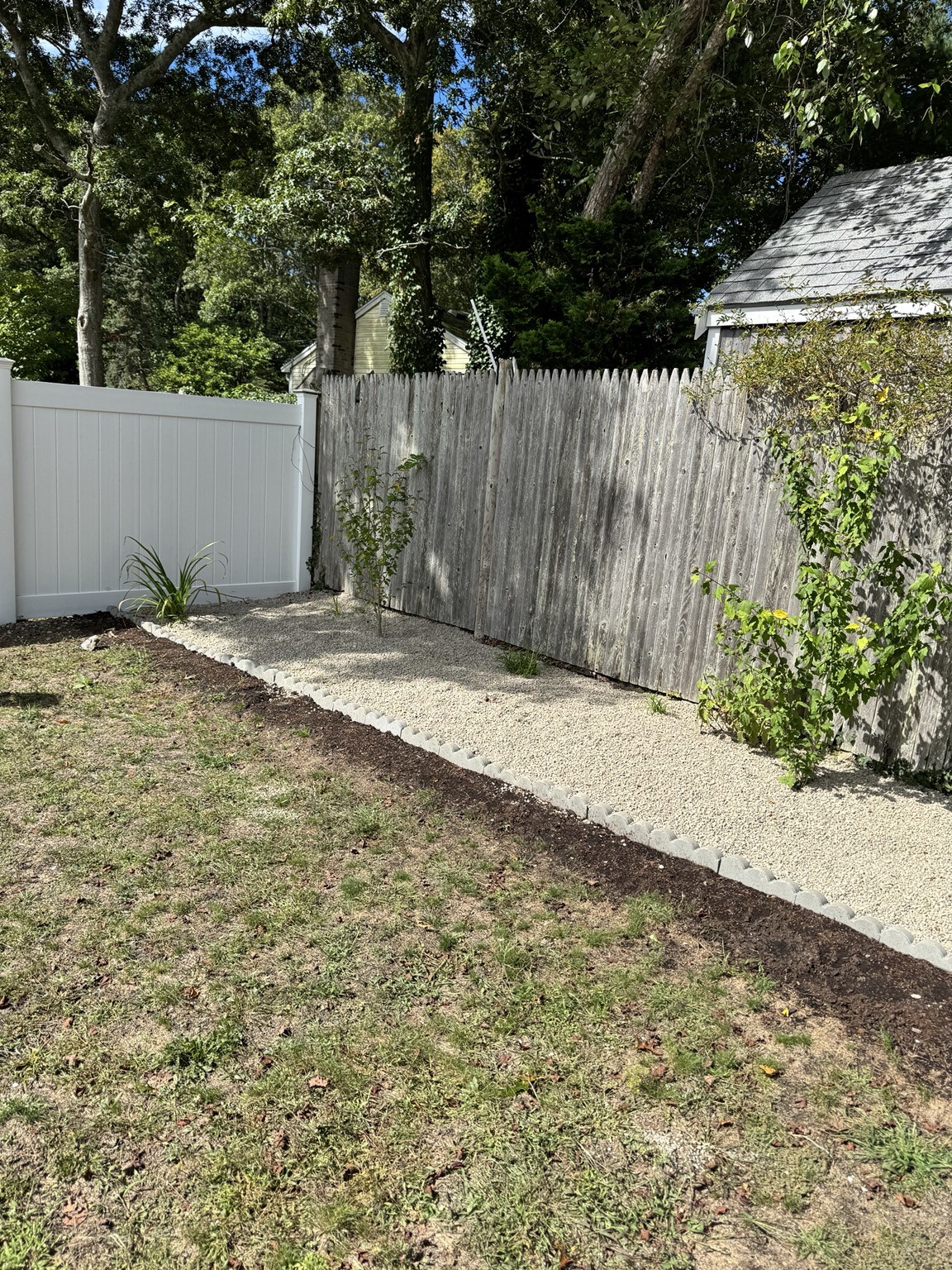 Finished stone landscape bed with a clean curved edge